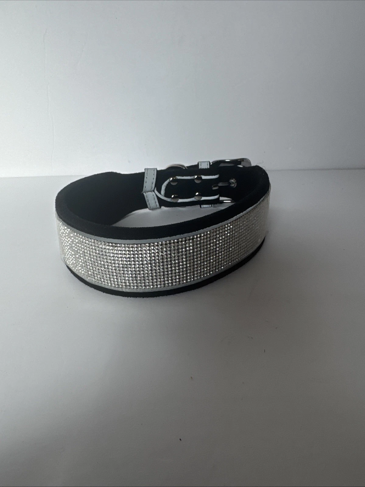 Black dog collar with multiple rows of rhinestones and durable hardware for pet.
Opens in a new wind