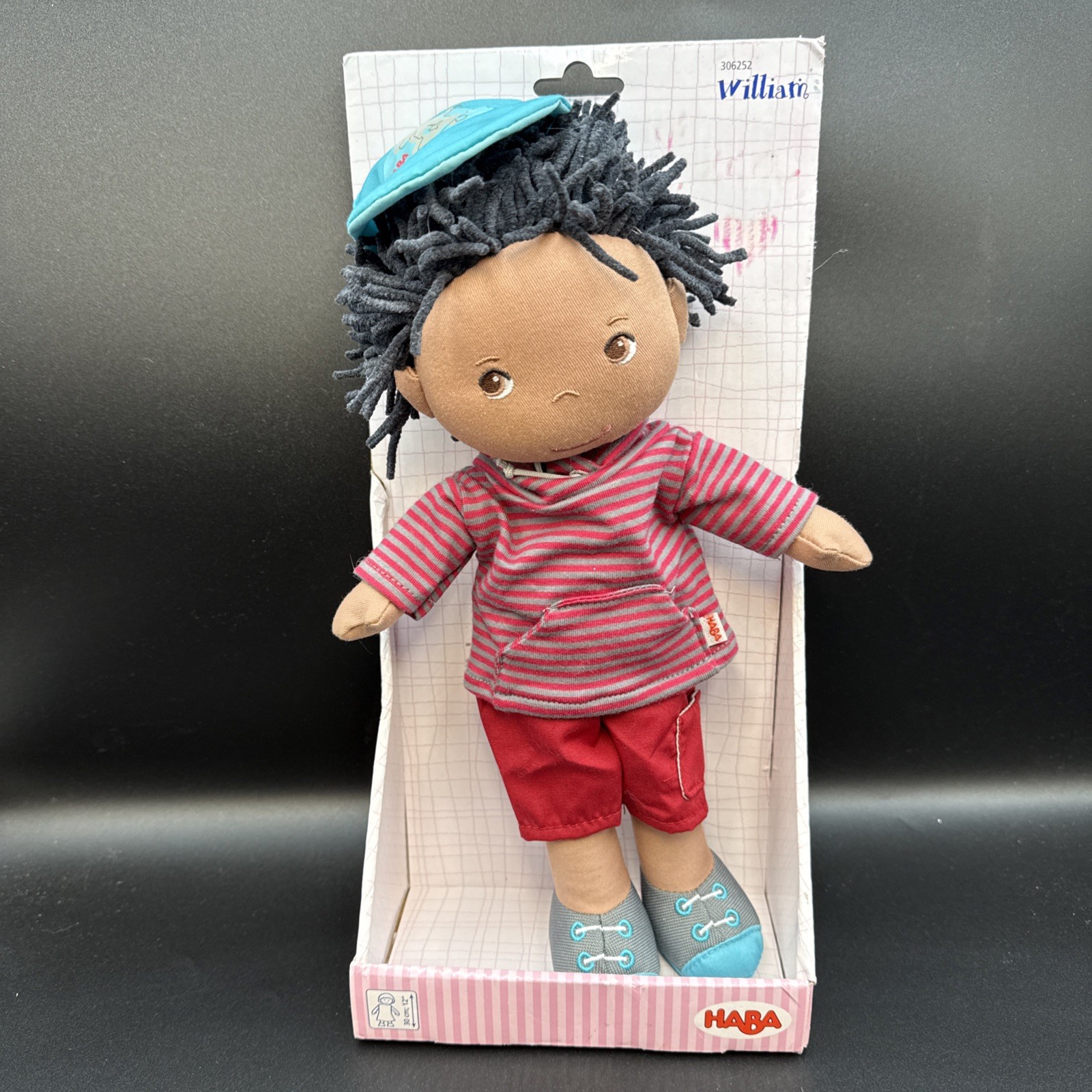 HABA William - 12" Soft Boy Doll with Black Hair, Hat and Ho
