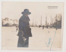 Elegant Woman in Wide-Brim Hat Strolling by the Harbor in Antique Coastal Scene