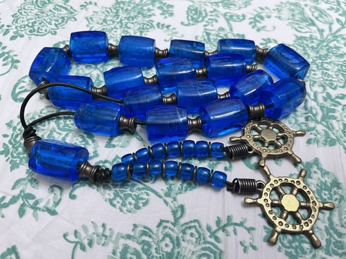 Hand Blown Cobalt Blue Beads. Brass Elements. Barrels. Two Ship Wheels.