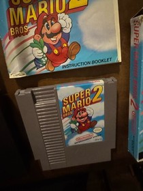 Carro Super Mario Bros 2 NES casi nuevo, caja sello ovalado caja Rev-A y manual (Dmg)