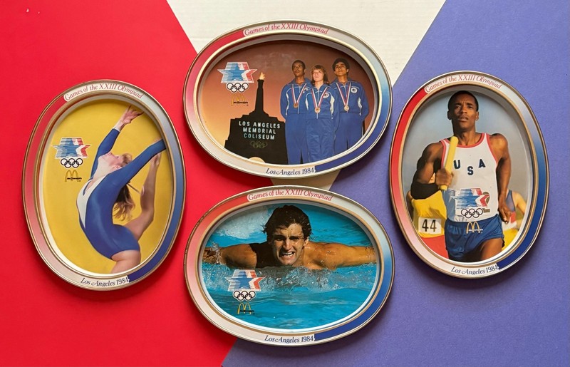 1984 LOS ANGELES - GAMES OF THE XXIII OLYMPIAD TIN PLATES (SET OF 4).