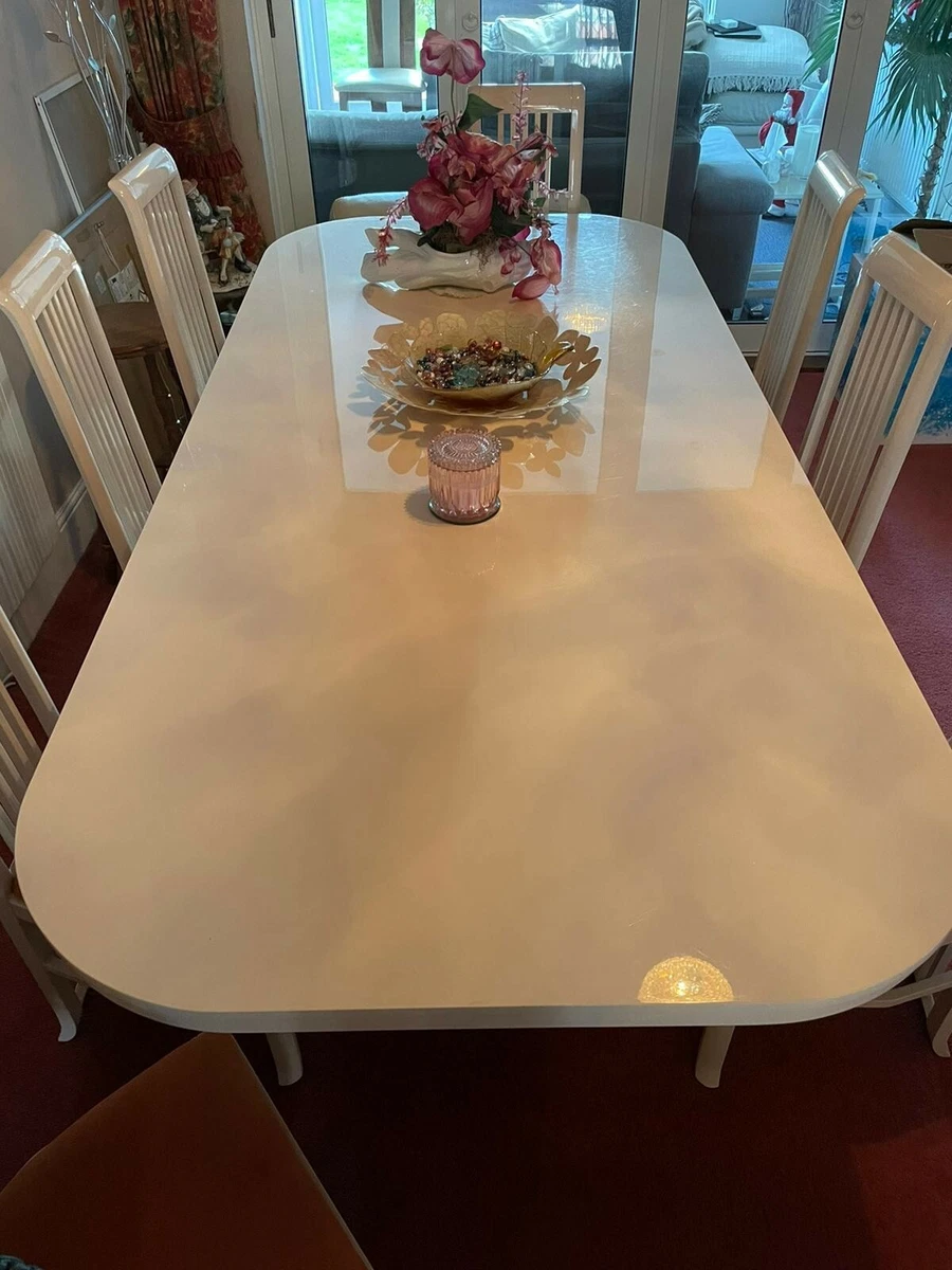 High gloss wood dining table with 8 chairs. used with surface scratches