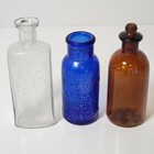3 Vintage Glass Bottles In A Variety Of Colors And Approx 4" - 5" Tall
