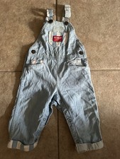 Vintage OshKosh B'gosh light blue denim baby overalls.
