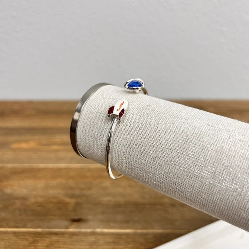 Bracelet features the Pizza Planet rocket and a blue planet Disney pixar