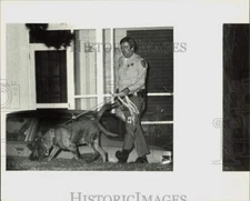 1981 Press Photo A police officer walks his Bloodhound dogs - lra45159