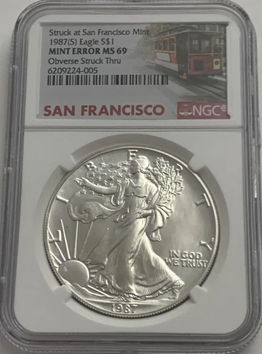 1987 S $1 NGC Mint Error MS69 America Silver Eagle Obverse Struck Thru Trolley