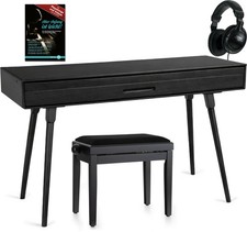 Eleganter Tisch in Schwarz matt mit Zubehör, der sich in ein Piano verwandelt