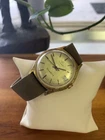 vintage gold-tone Timex Q Quartz watch with a champagne dial