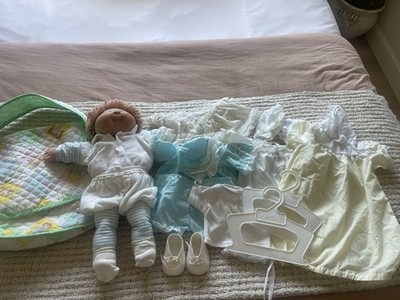 collection of vintage Cabbage Patch Kids dolls and accessories from the 1980s