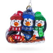 Penguin Trio Sledding Glass Ornament