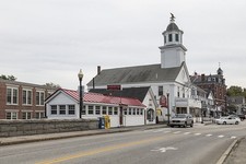 View past a bridge over the Sohegan River to downtown Milford, New Hampshire