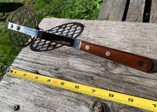 vintage stainless steel potato masher with a wood handle well made