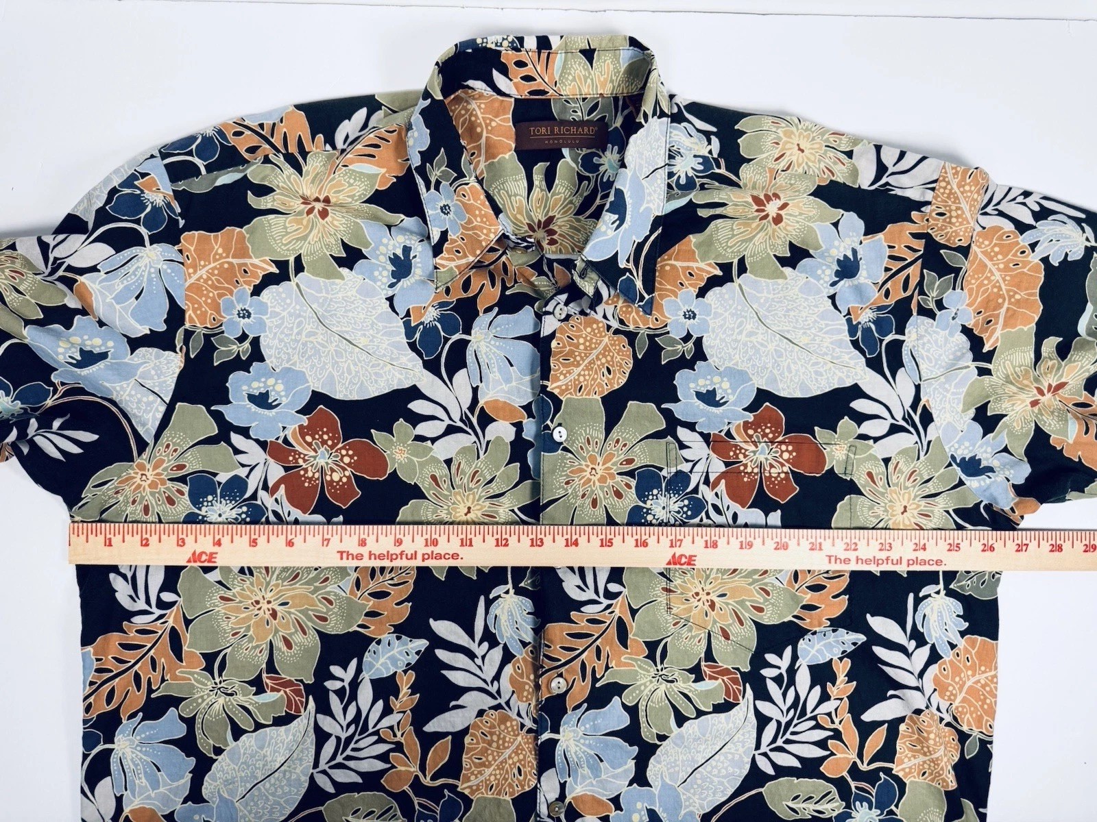 Navy blue Hawaiian shirt mens 2XL with orange, yellow, and blue floral print and green leaf pattern, made in USA.