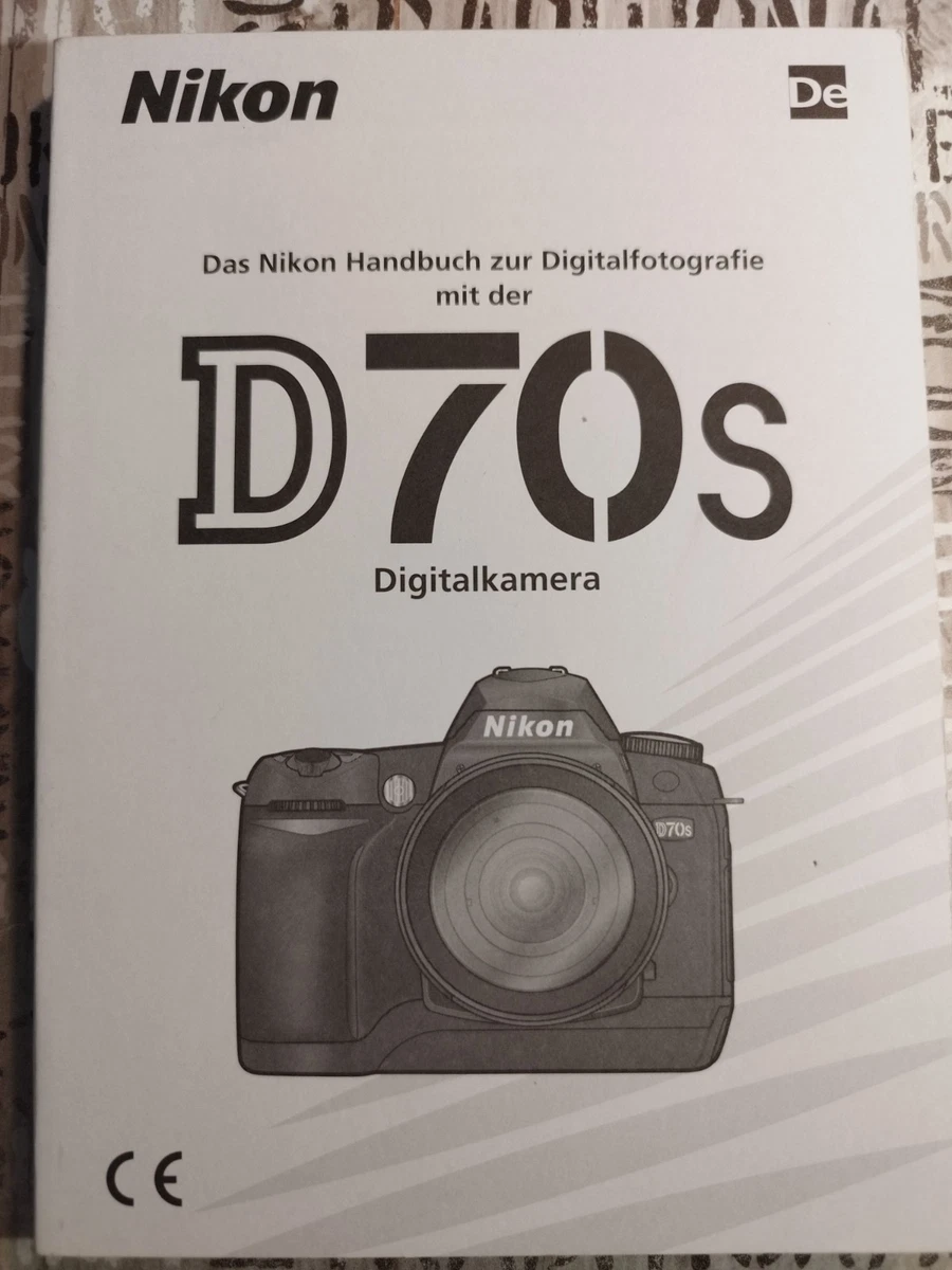 A Nikon F-301 camera body with instruction manual and book, together