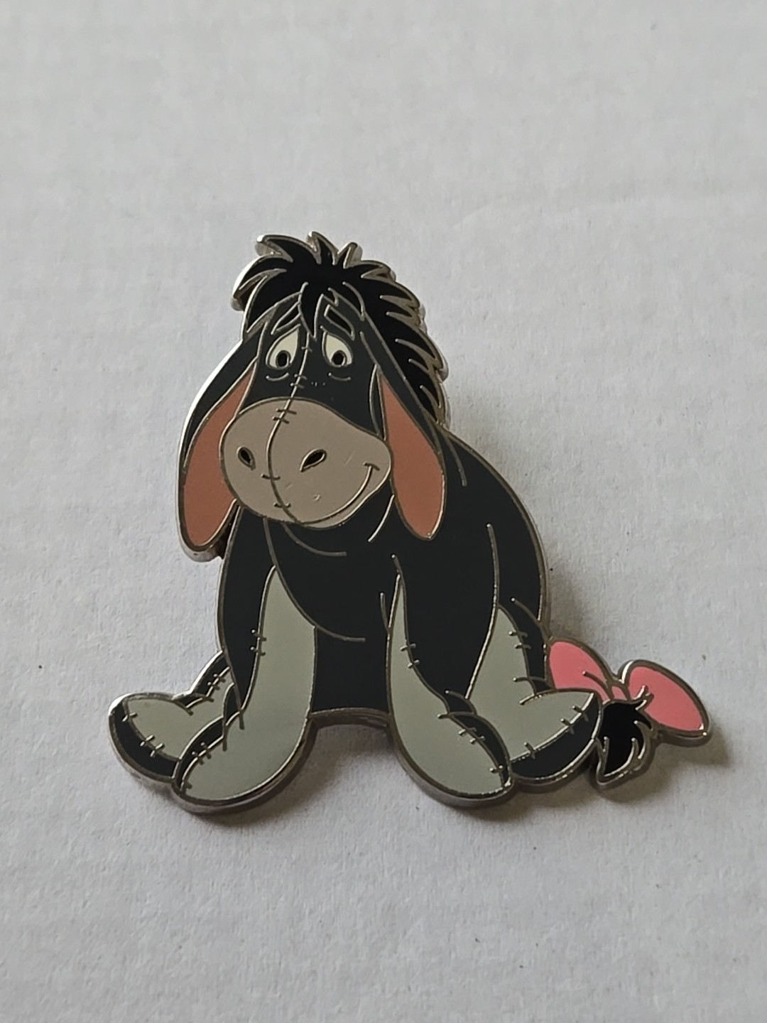 2007 Disney Eeyore Smiling Sitting Pink Bow from Winnie the Pooh Trading Pin
