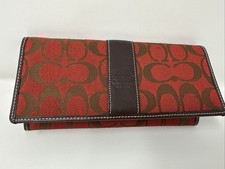 Vintage Coach signature red canvas bifold wallet with a brown leather trim.