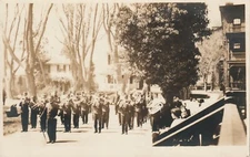RPPC -- Marching Band on Street of Residential Homes -- Location Unknown