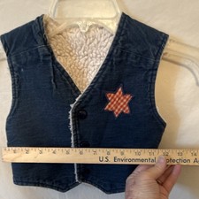 vintage-style children's denim vest a sherpa lining and red gingham star patch.