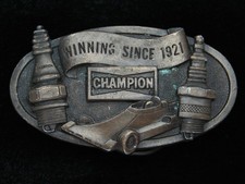 QI11119 VINTAGE 1978 CHAMPION WINNING SINCE 1921 SPARK PLUG AUTO RACING BUCKLE
