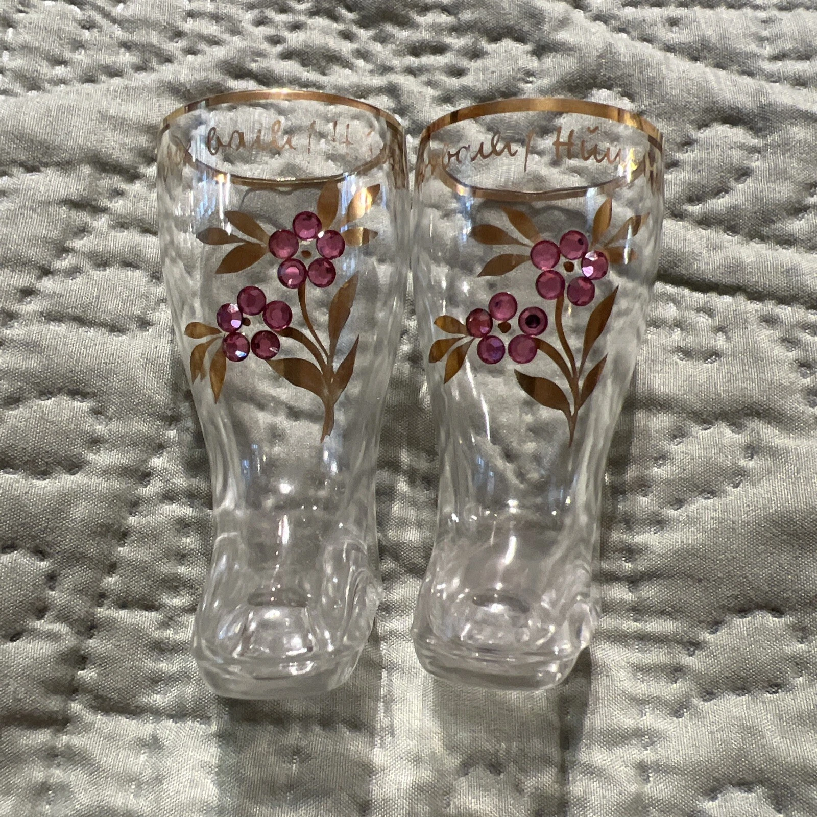 A lot of two German boot shaped glasses with gold hand painting and rhinestones