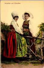 Postcard Sweden Women Wing�ker & �ster�ker Folk Costumes talking across fence