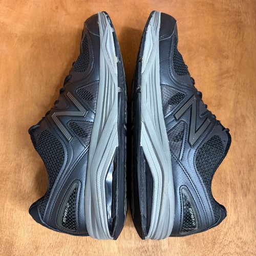 Black and gray New Balance 1540V2 men’s running shoes with mesh uppers, suede overlays, and textured rubber soles.
