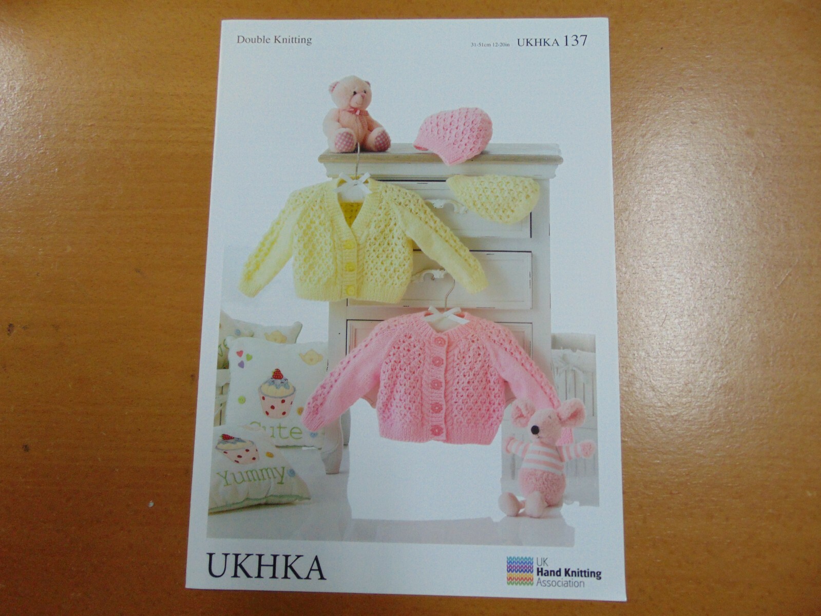UKHKA Double Knitting Pattern 137  Cardigans and Hat (12 - 20 in)
