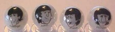A Set of 4 The Beatles Cartoon Glass Marbles