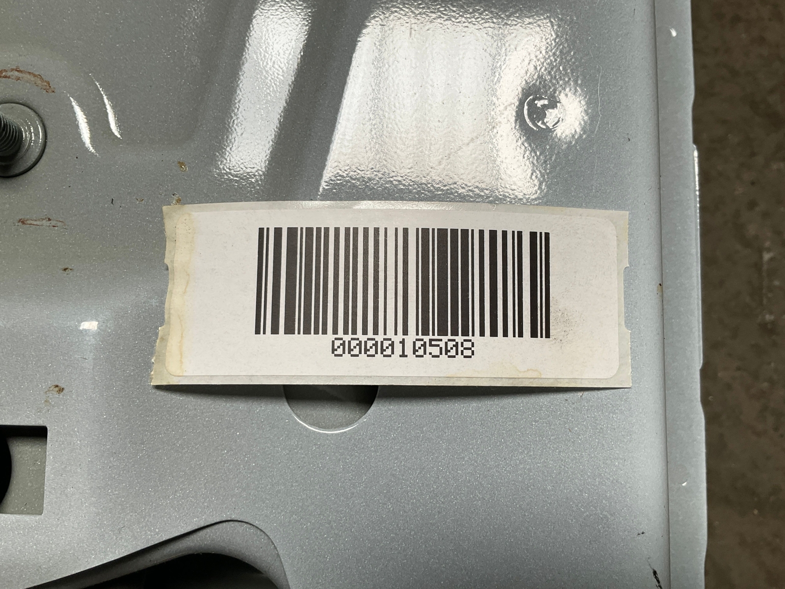 Silver 13-18 RAM 1500 side driver frame apron with white barcode label reading “000010508” on rusted edge.