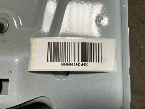 Silver 13-18 RAM 1500 side driver frame apron with white barcode label reading “000010508” on rusted edge.