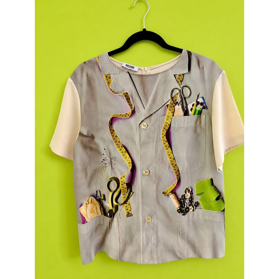 A genuine Moschino Cheap & Chic blouse with a seamstress novelty print — wearable fashion art from the era when Moschino was at peak wit.