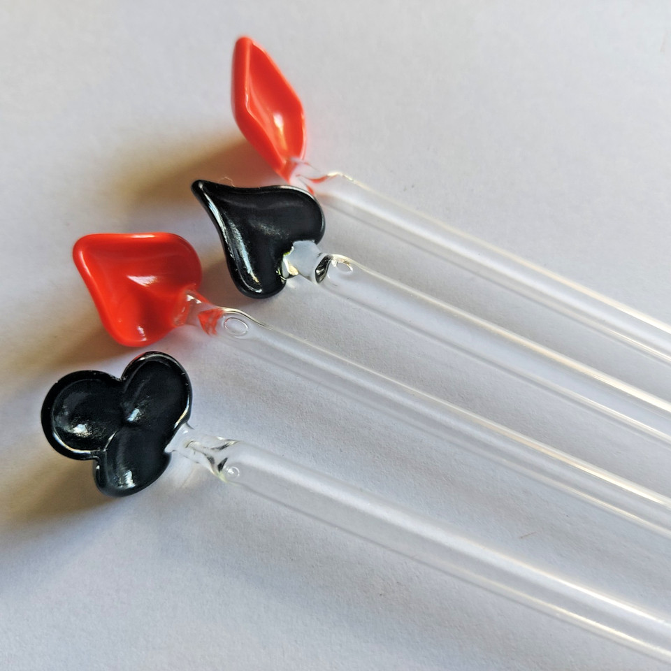 Hand-blown glass swizzle sticks shaped like playing card suits — rare, fragile, and exactly the kind of thing you'd find in a great antique shop and never see again.