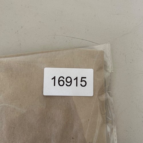 Tan vintage 80s military stencil shirt, size large, with white label reading “16915” and USA Made text on fabric.