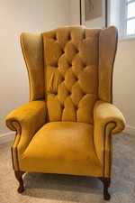 An Oswald And Pablo Grande Chesterfield Wing Chair In Mustard Velvet.