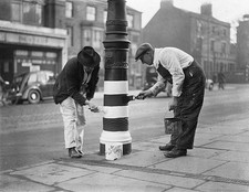 Corporation workers paint a lamp-post ready for a huge trial black- Old Photo