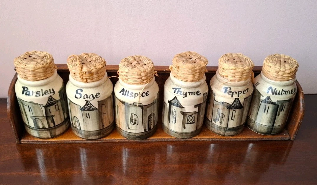 Vintage Ceramic Spice Set. 6 spice jars with indiv designs on wooden rack.
Opens in a new window or