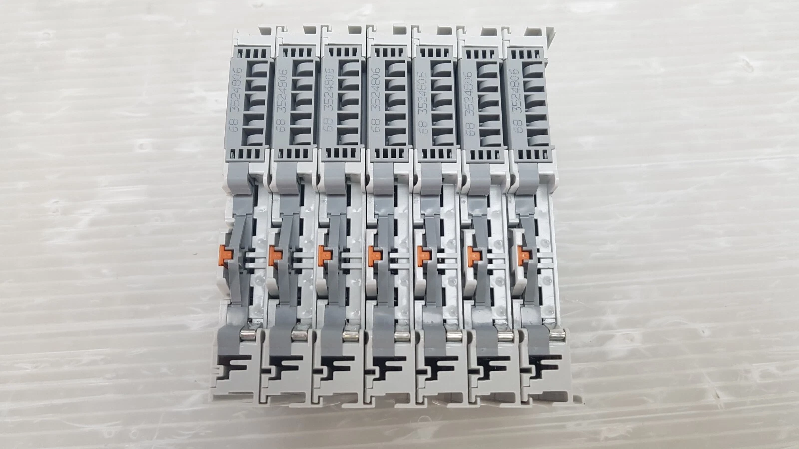 Underside of seven KL3002 terminals with DIN rail latches