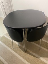 Dining table and 4 chairs. Modern black dining table with four matching black ch