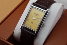 Vintage Seiko Slim Quartz Men's Wrist Watch Yellow Dial with Dark Brown Strap.