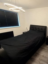 Black faux leather TV bed with built-in TV lift
