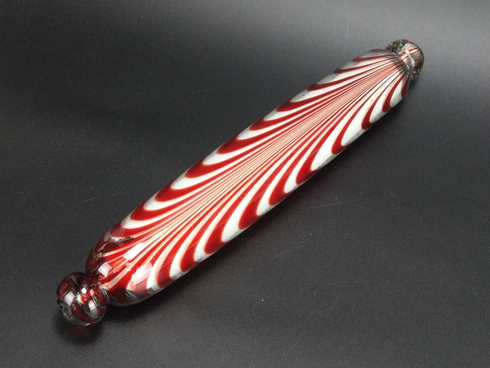 Antique rolling pin made from red Nailsea glass and filled with plaster