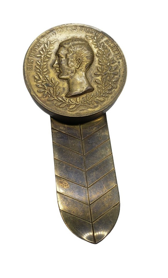 Antique Italian brass Prince Albert desk clip with a hidden pill/snuff compartment — a secret-compartment antique that's equal parts functional curiosity and conversation piece.
