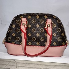small little girls purse pink and brown and tan with pink handles and bottom
