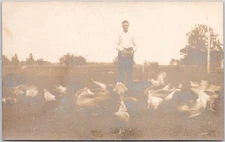 Vintage RPPC Postcard Man Feeding Geese Farmyard Scene Unposted AZO Stamp Box