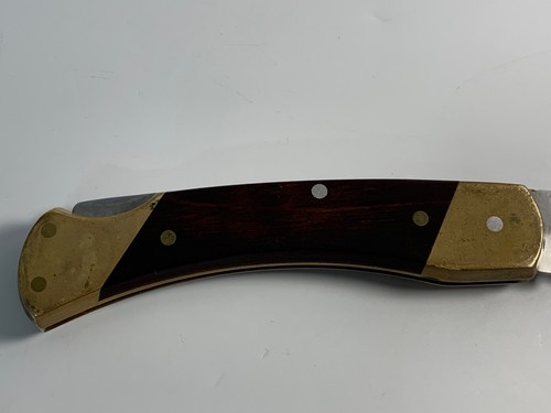 Vintage Schrade Uncle Henry LB 7 lockback with brass bolsters, dark wood handle, and “Made in U.S.A.” engraving.