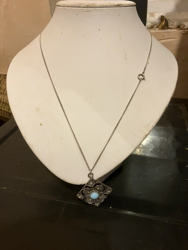white metal and blue stone pendent and chain