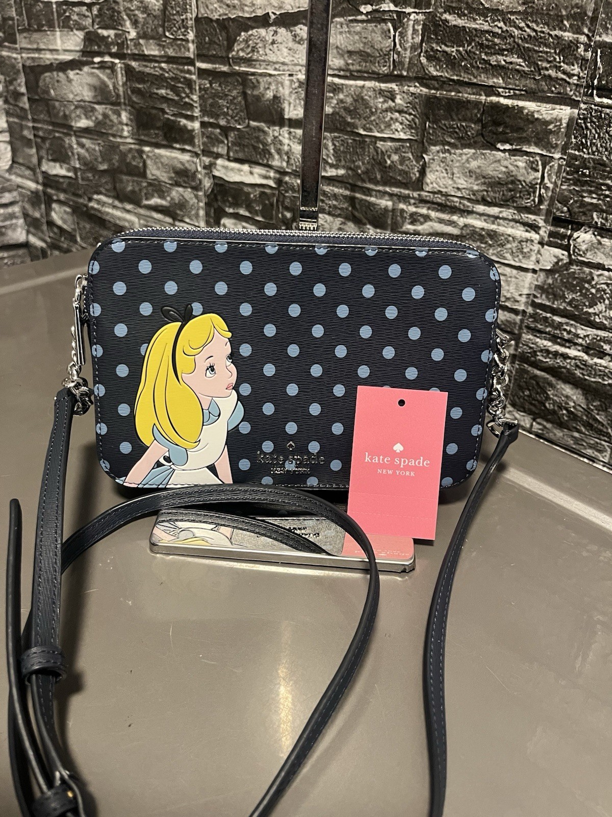 Kate Spade New York Disney x Alice in Wonderland polka dot crossbody bag.