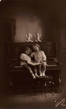 Two Young Girls Sit on Piano Singing Fotocelere Italy Real Photo RPPC Postcard